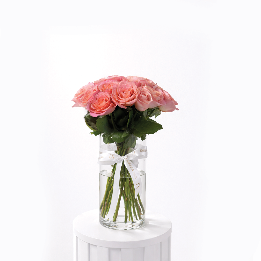 25 pink roses arranged in a clear glass vase for sale in Dubai with same day delivery