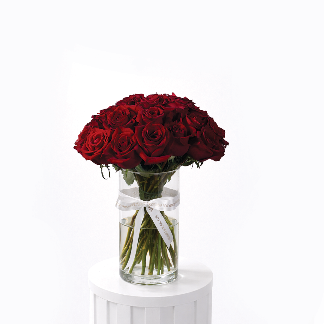 25 red roses arranged in a clear glass vase for sale in Dubai with same day delivery