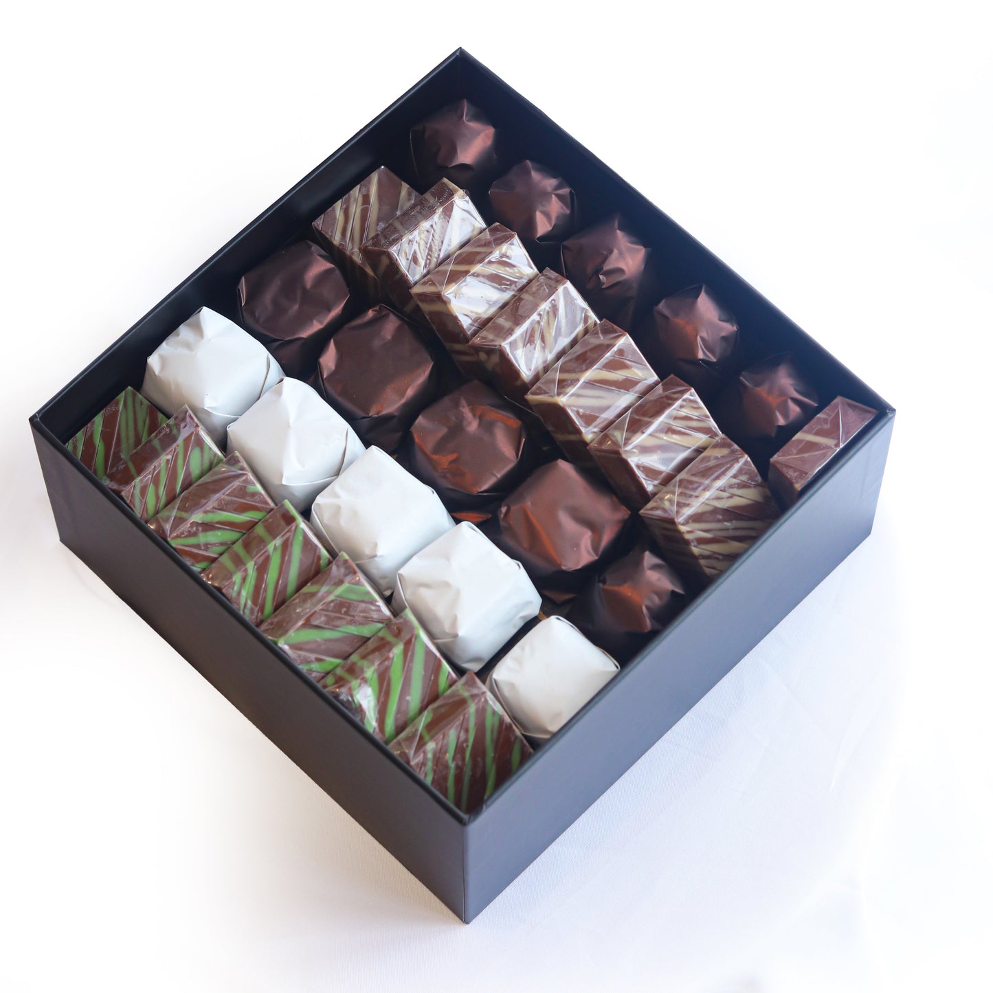 Box of assorted chocolates on a white background