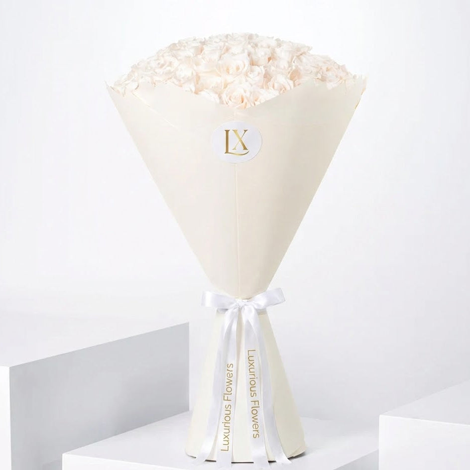 Floral arrangement in a cone-shaped white paper wrap with a visible brand logo on a white background