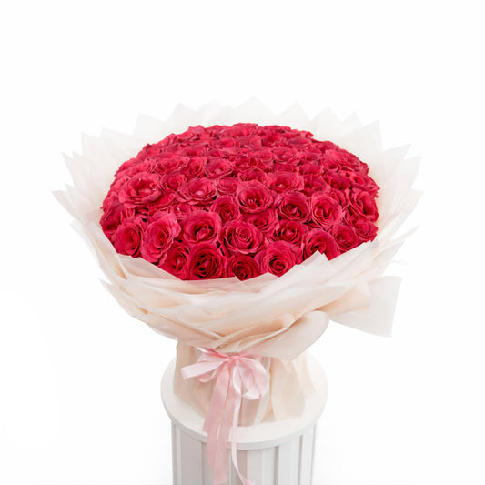 Grand 100 fuchsia rose bouquet in luxury designer wrapping for sale in Dubai