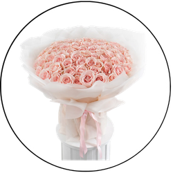 Bouquet of pink roses in a clear vase with a white ribbon on a white background