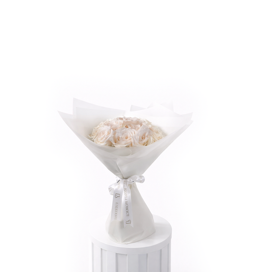 Elegant 12 white roses bouquet wrapped in luxury white paper for sale in Dubai