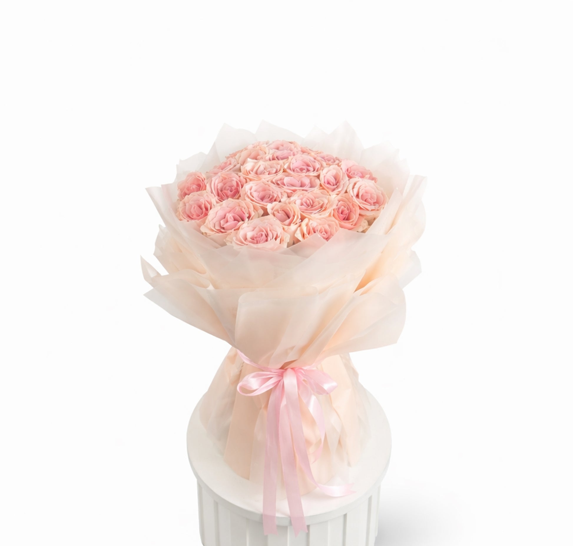Hand-tied bouquet of 25 pink roses wrapped in soft blush paper with ribbon