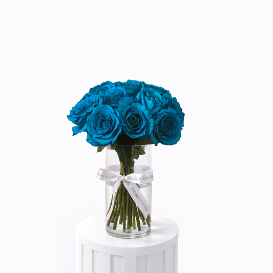 25 blue roses arranged in a clear glass vase for sale in Dubai online with same day delivery