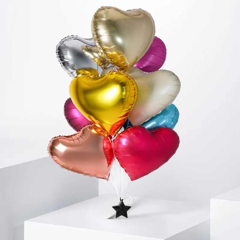 Colorful heart-shaped foil balloons on a white background