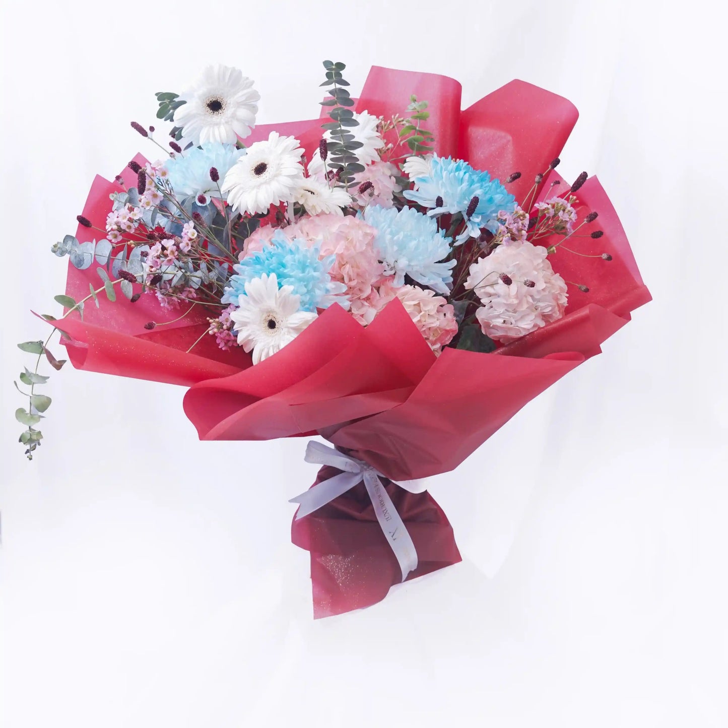 Bouquet of flowers wrapped in red paper on a white background