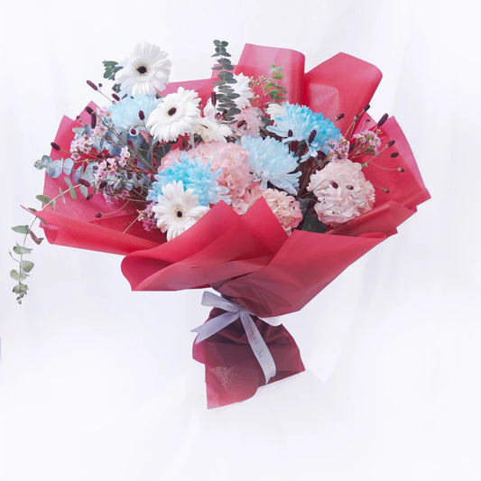 Bouquet of flowers wrapped in red paper on a white background