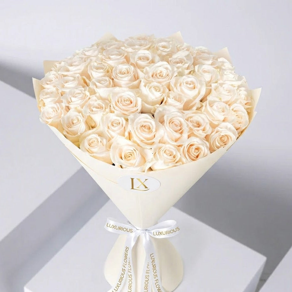 Bouquet of white roses with 'LUXURIOUS' branding on a light gray background