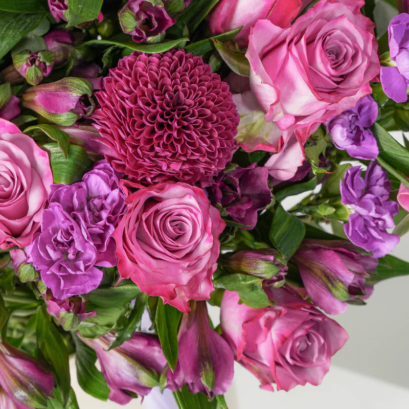 Bouquet of pink and purple flowers with green leaves