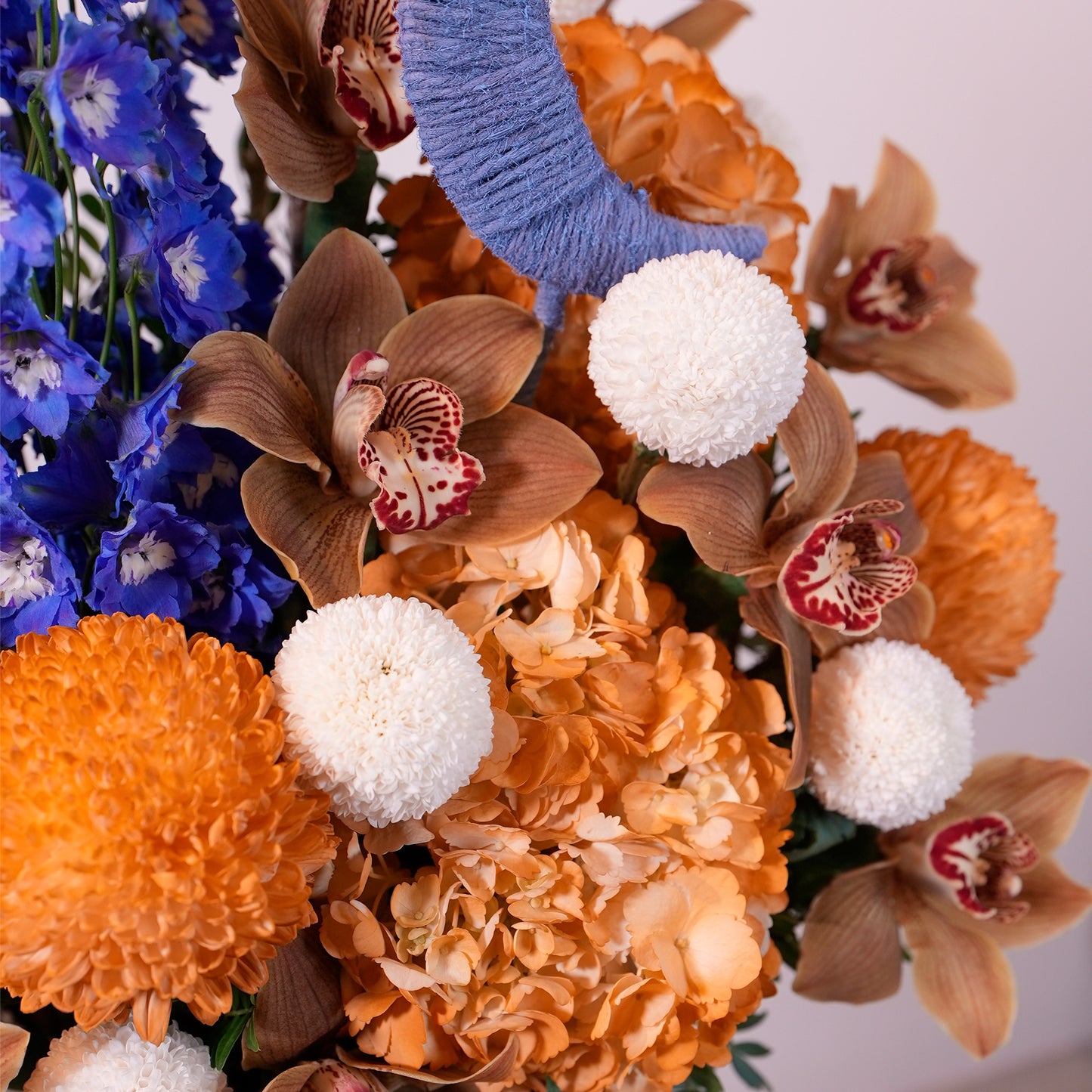 Luxury Ramadan flower arrangement in white box with crescent moon accents, blue delphiniums, orange hydrangea, for sale in Dubai