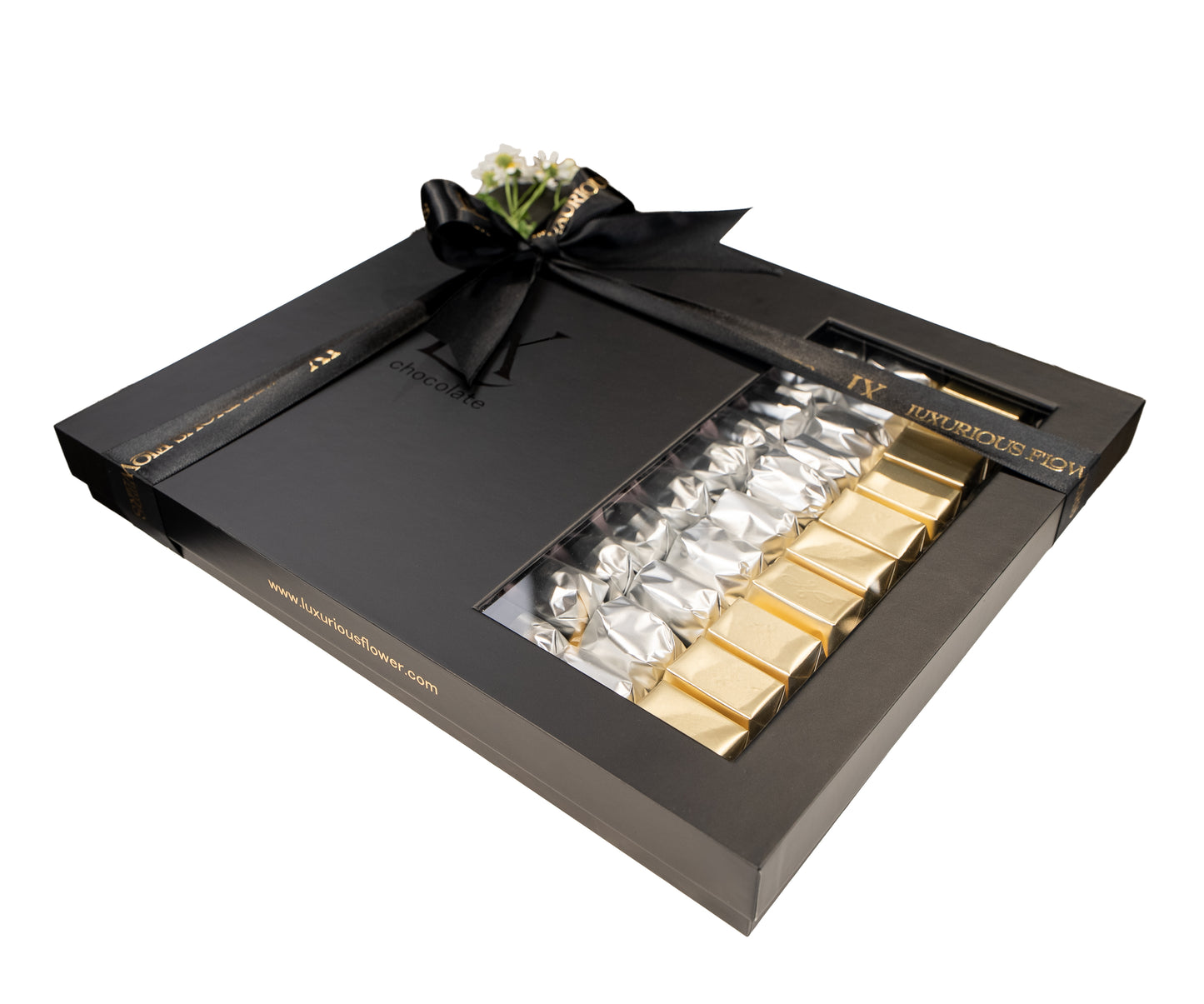 Luxury chocolate set with gold and silver bars in a black box on a white background