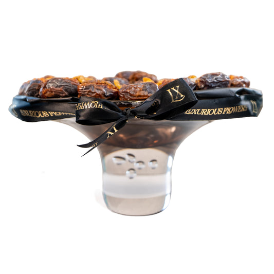 Luxury medjool dates arranged in an elegant glass bowl, tied with a branded black ribbon, perfect as an upscale gift item