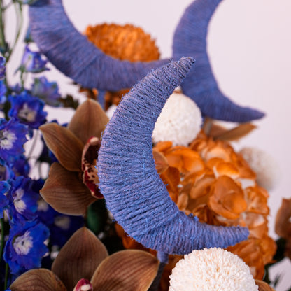 Decorative blue crescent moon with flowers and seashells on a white background for sale in Dubai