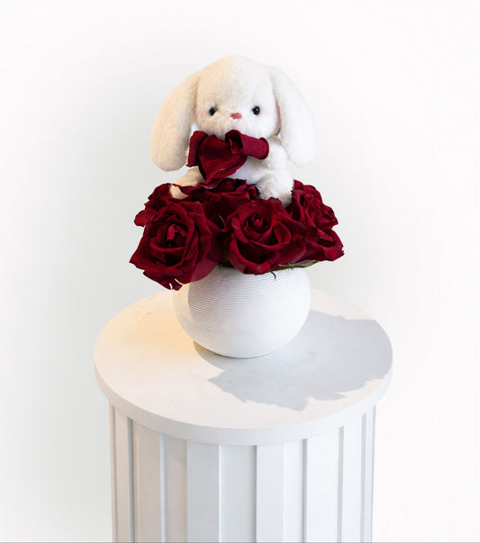 Teddy bear with red roses arrangement in a white vase by Luxurious Flowers Dubai for sale in Dubai
