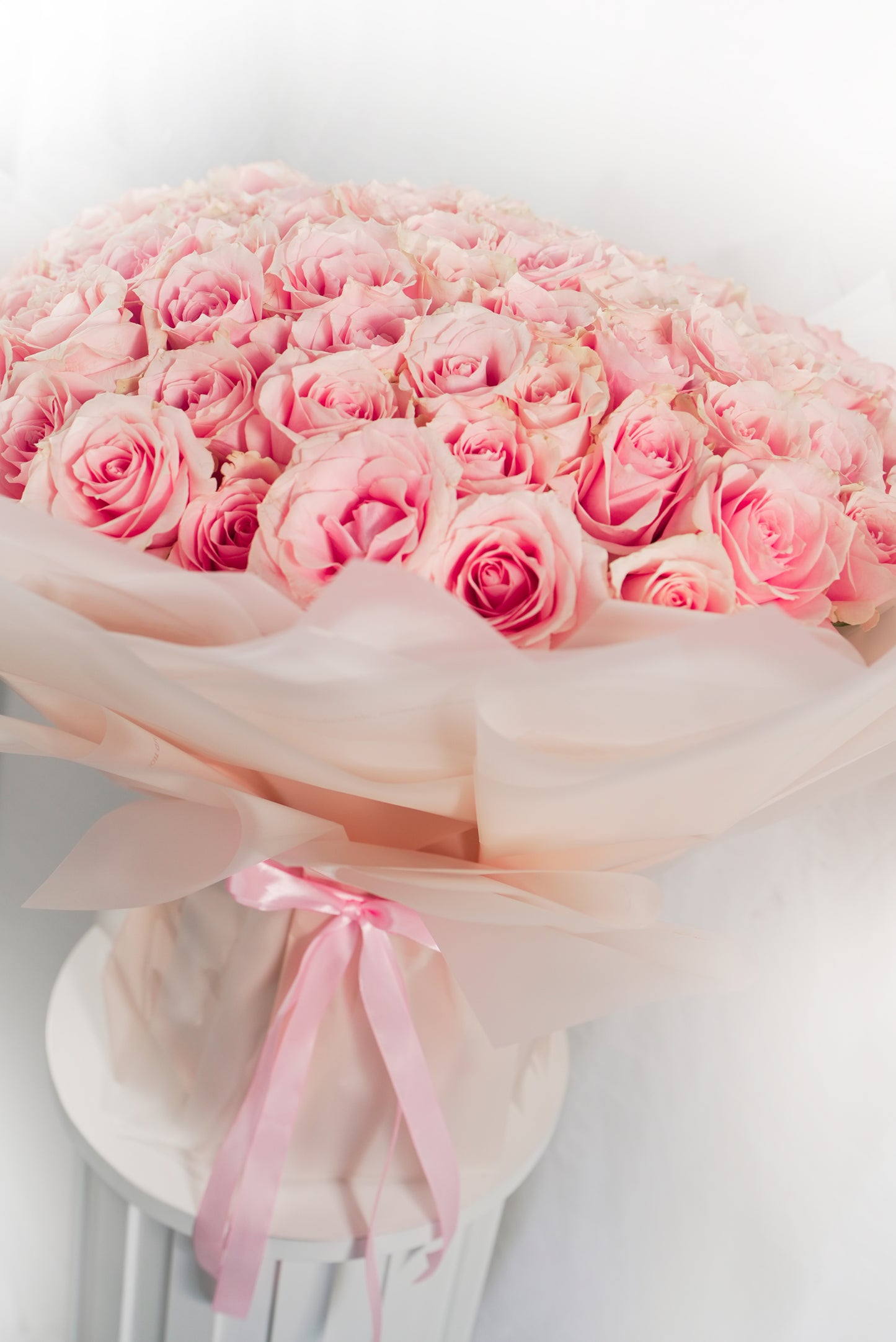 Detailed view of soft apricot rose petals in a 100-stem arrangement for sale Dubai