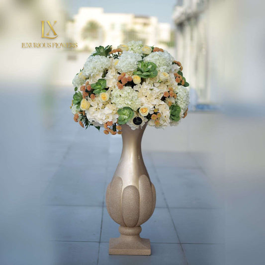 Luxurious White and yellow lilies in round glass vase with a pedestal base. - Luxurious Flowerssimple
