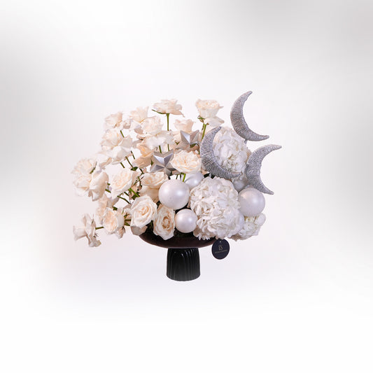 Luxury white and silver Ramadan flower arrangement with crescent moon décor in black pedestal vase by Luxurious Flowers Dubai